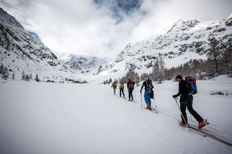 A group of skiiers traverse a snow ridge on the Haute Route in Chamonix.