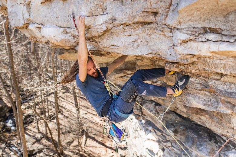 A man climbing a steep sport climb in Chattanooga, TN