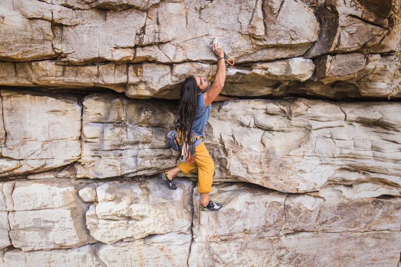 A climber clipping into a bolt with a quickdraw on a wall in Chattanooga, TN