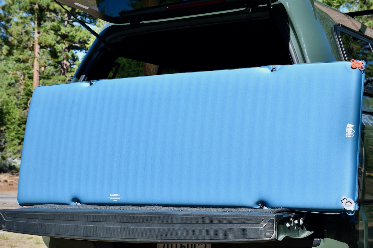 The REI Campwell sleeping pad set up on a truck bed on a sunny day