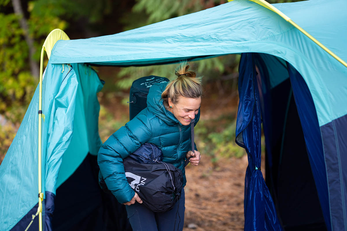 A camper standing fully upright under the vestibule of the Wawona tent.
