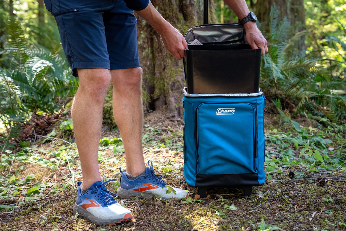 A man removes the insert in his cooler for cleaning.