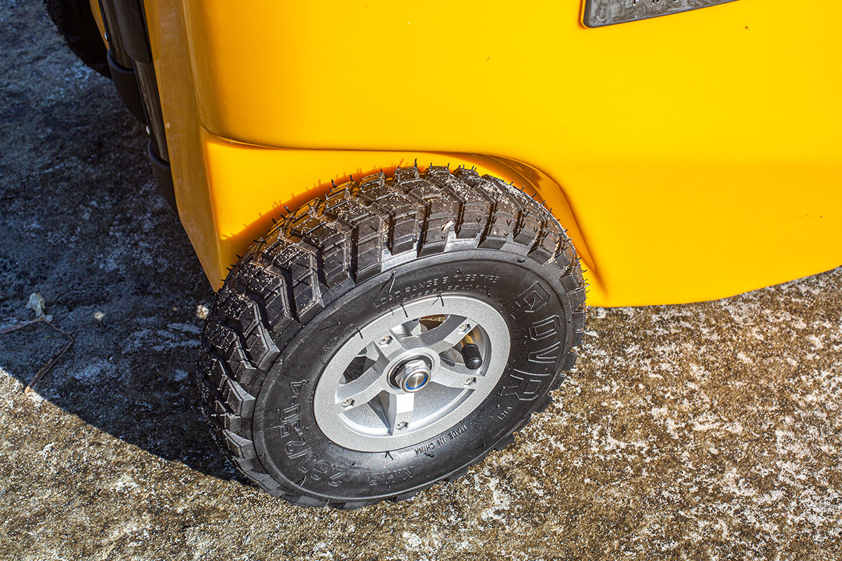 Close up image of a nubby cooler wheel that can handle rough terrain.