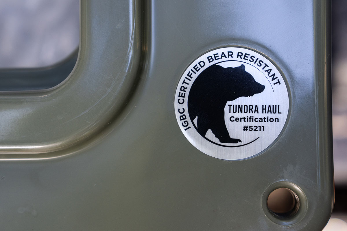 A wheeled Yeti cooler has a sticker designating it as bear proof. 