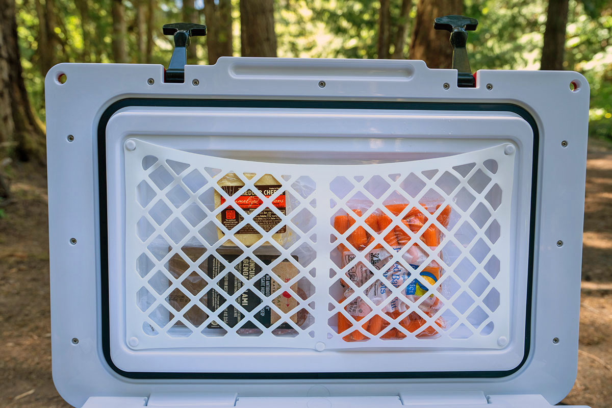 The RTIC cooler has a silicone net on the interior to stash snacks.