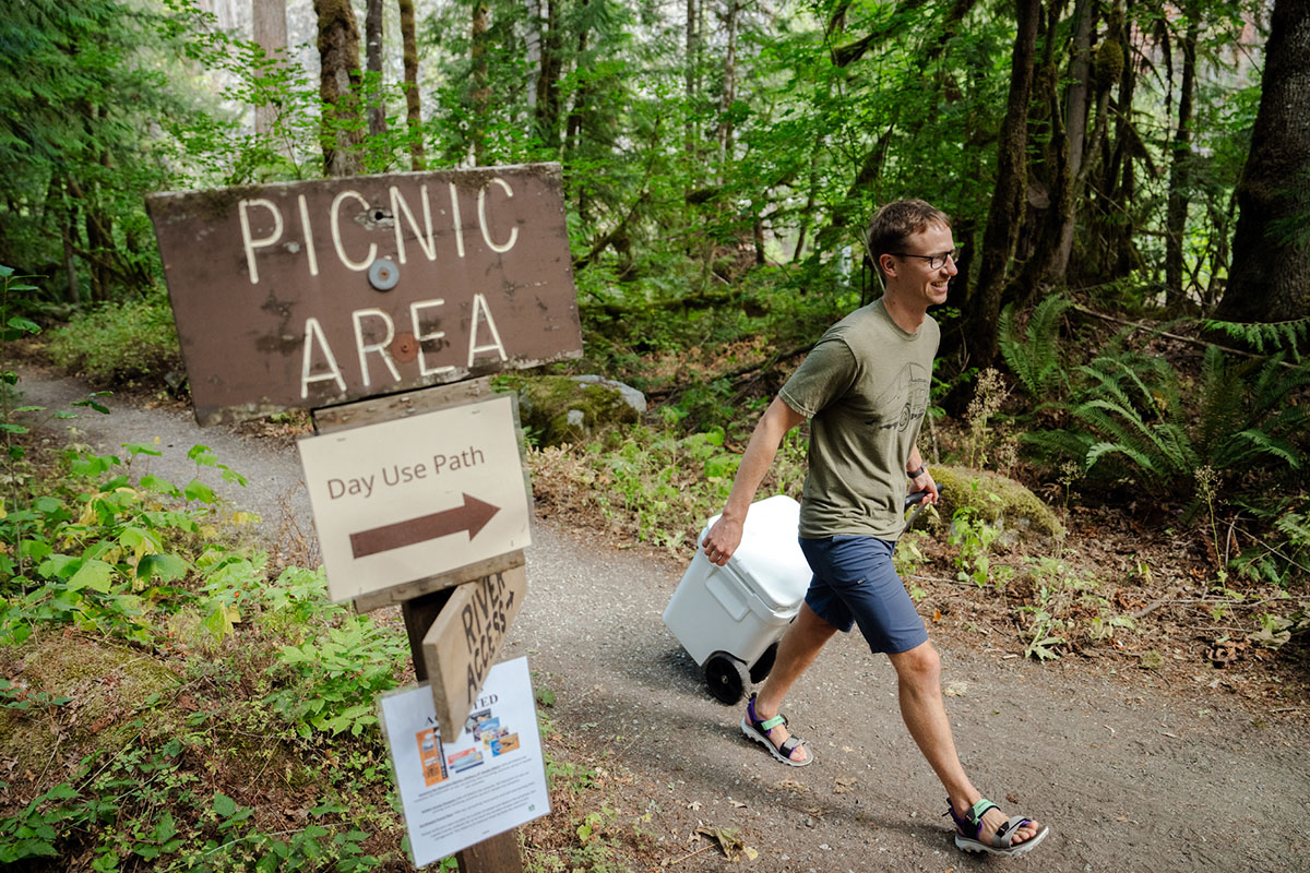 A happy camper wheels his cooler to the group picnic area.