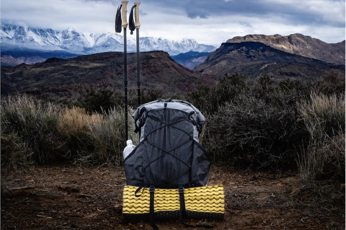 A closeup pic of a backpack with mountains in the background