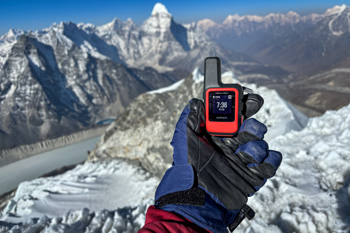 Showing the Garmin inReach Mini 2 in Nepal with snowy mountains in the background