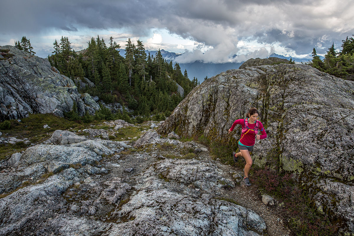 A woman in running in the Altra Lone Peak shoes in a rocky area