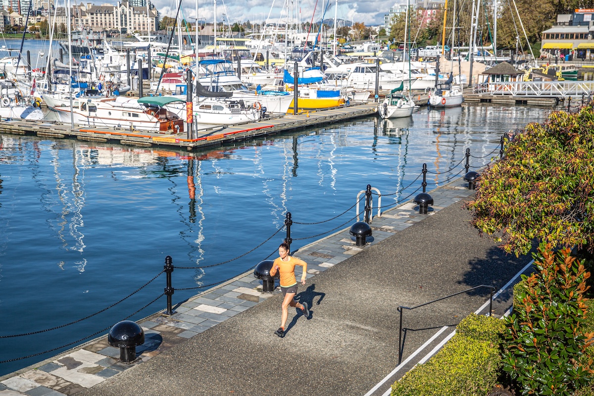 A woman is running near the harbor testing running shoes 