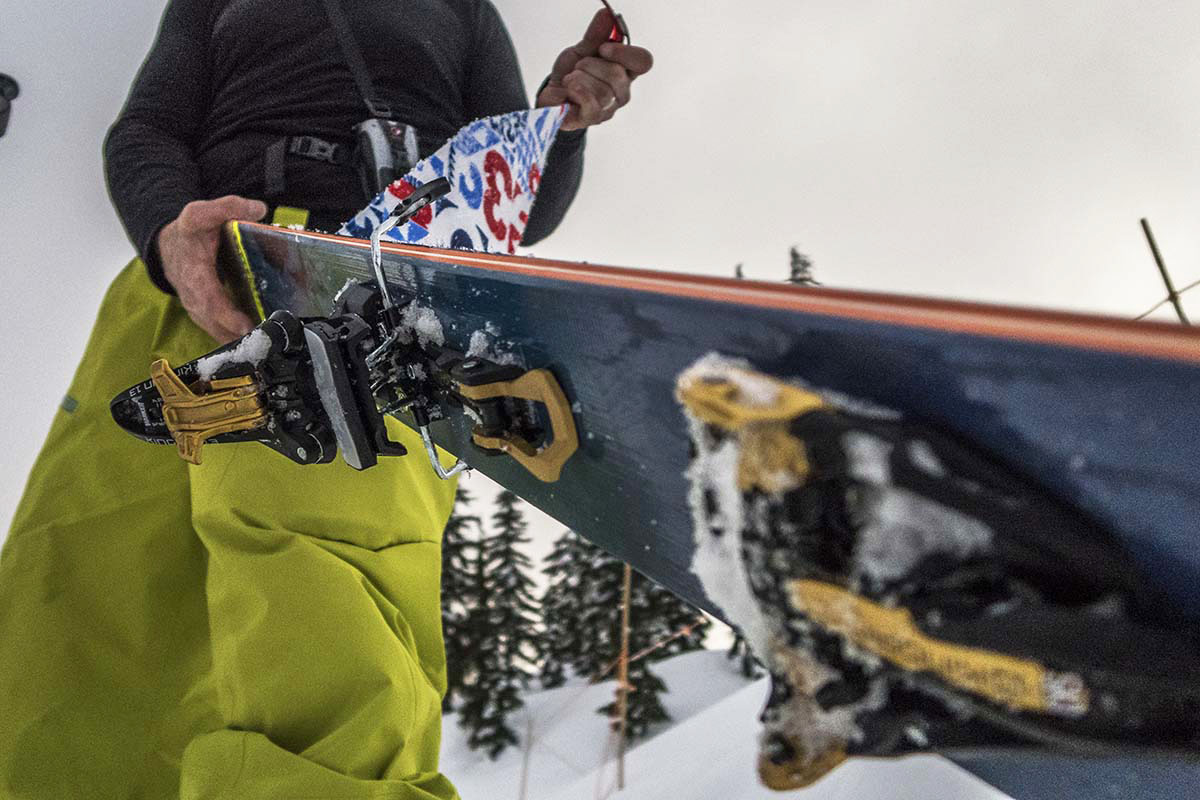 A skier removing the skins of some backcountry skis
