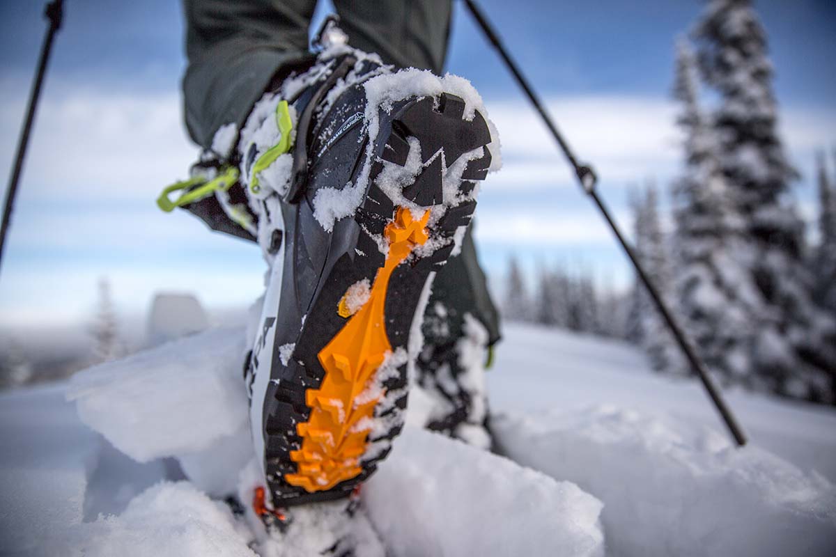 A close up of a backcountry ski boot with the heel up