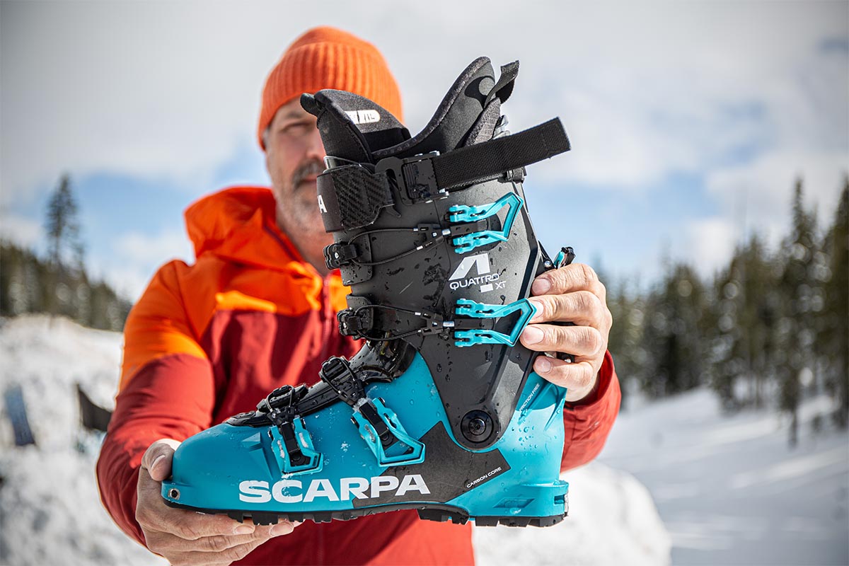 Holding up the Scarpa 4-Quattro XT boots for the camera