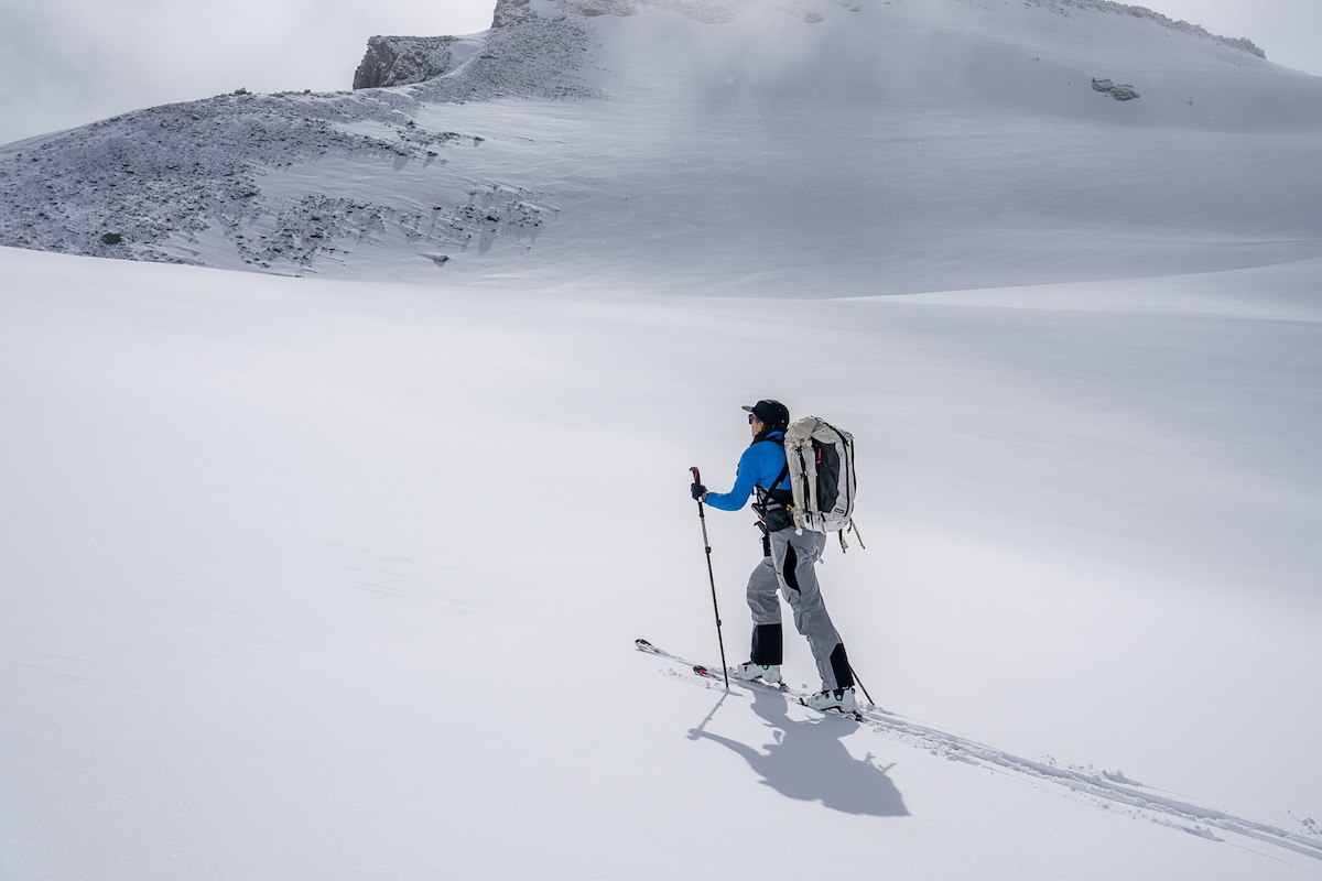 A woman ski tours up Mount Rainier in fresh snow