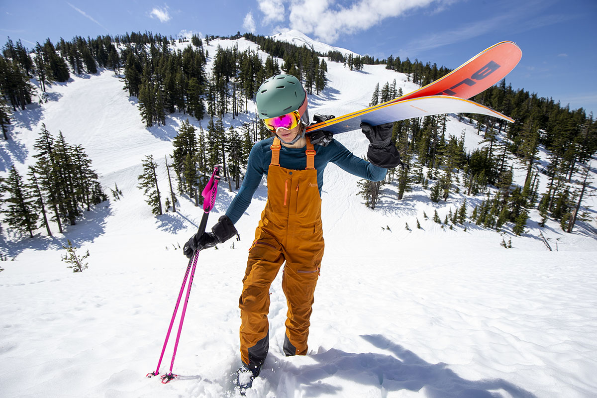 A woman hiking with skis in the Smartwool Intraknit