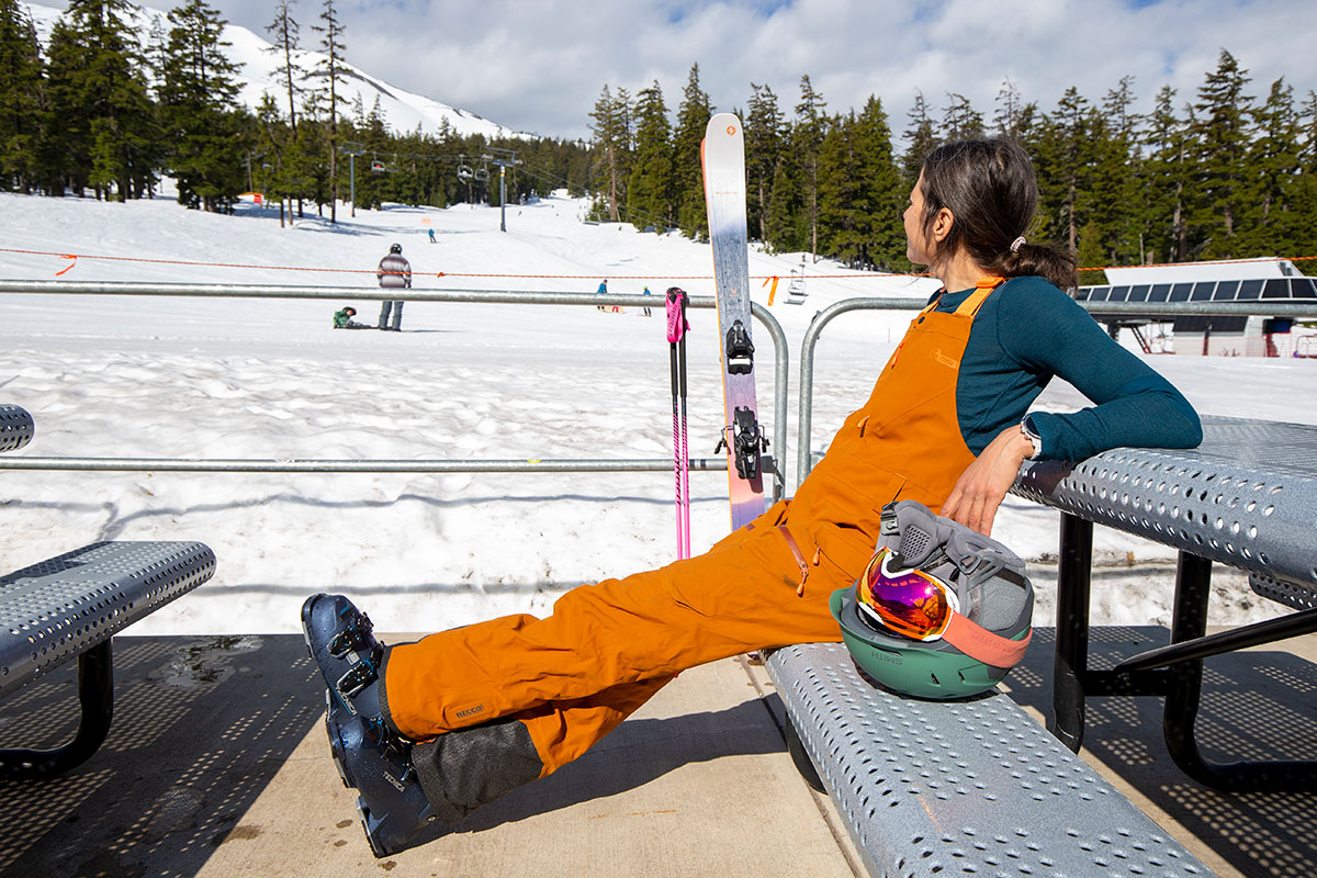 A woman relaxing on a bench wearing budget ski gear