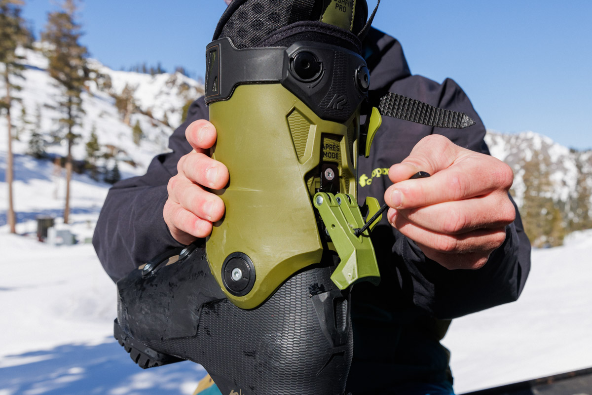 A walk ski lever on a pair of green ski boots