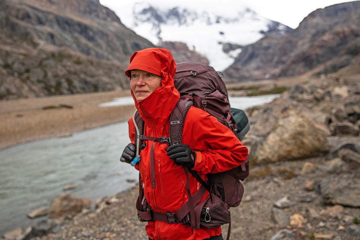 A woman backpacks with the Arc'teryx Beta SV hardshell jacket