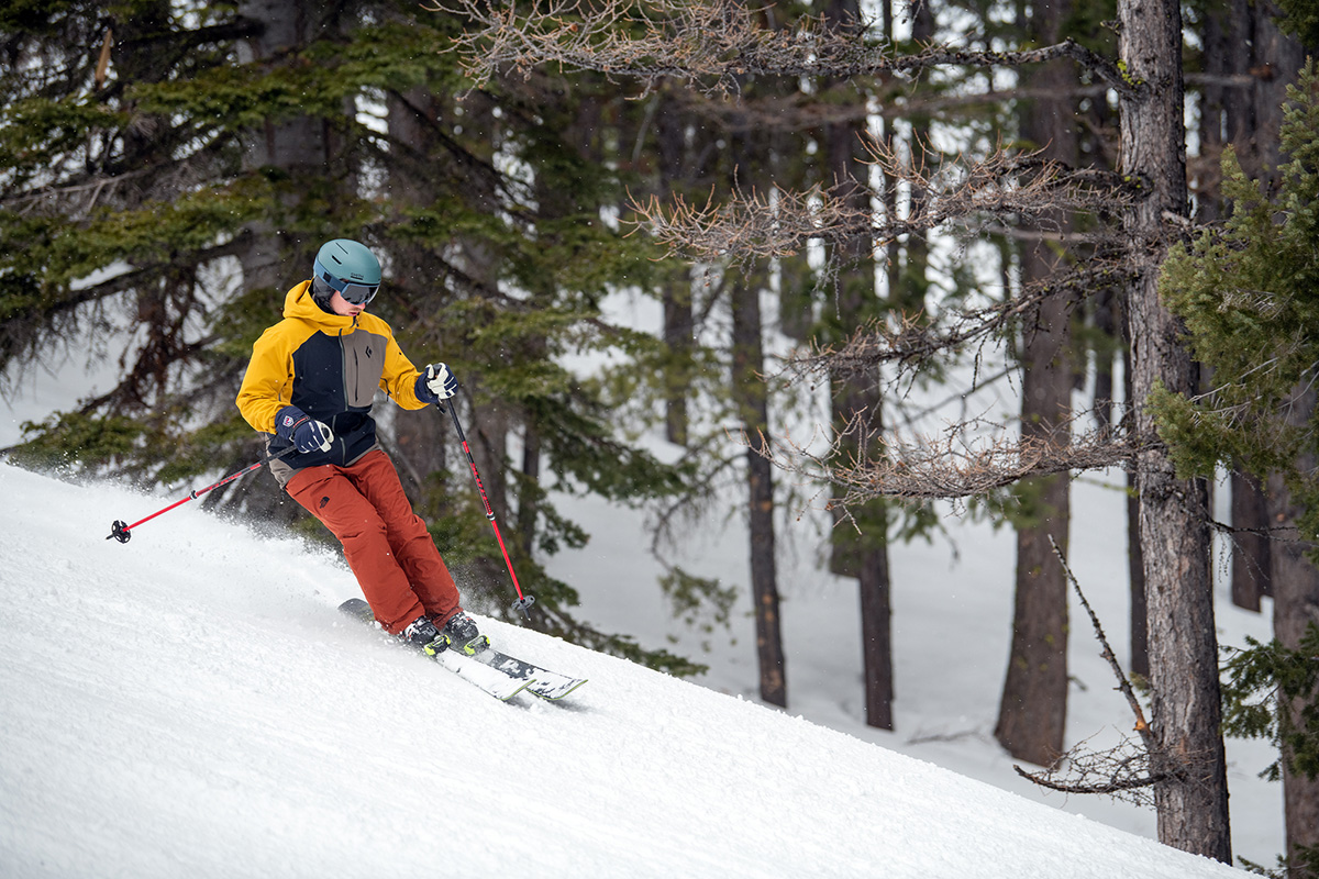 A man skiing next to trees with the Tyrolia Attack 11 bindings