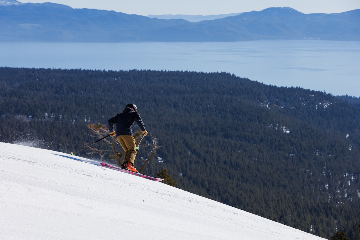 A skier makes a turn to go down a slope on a sunny day in Tahoe