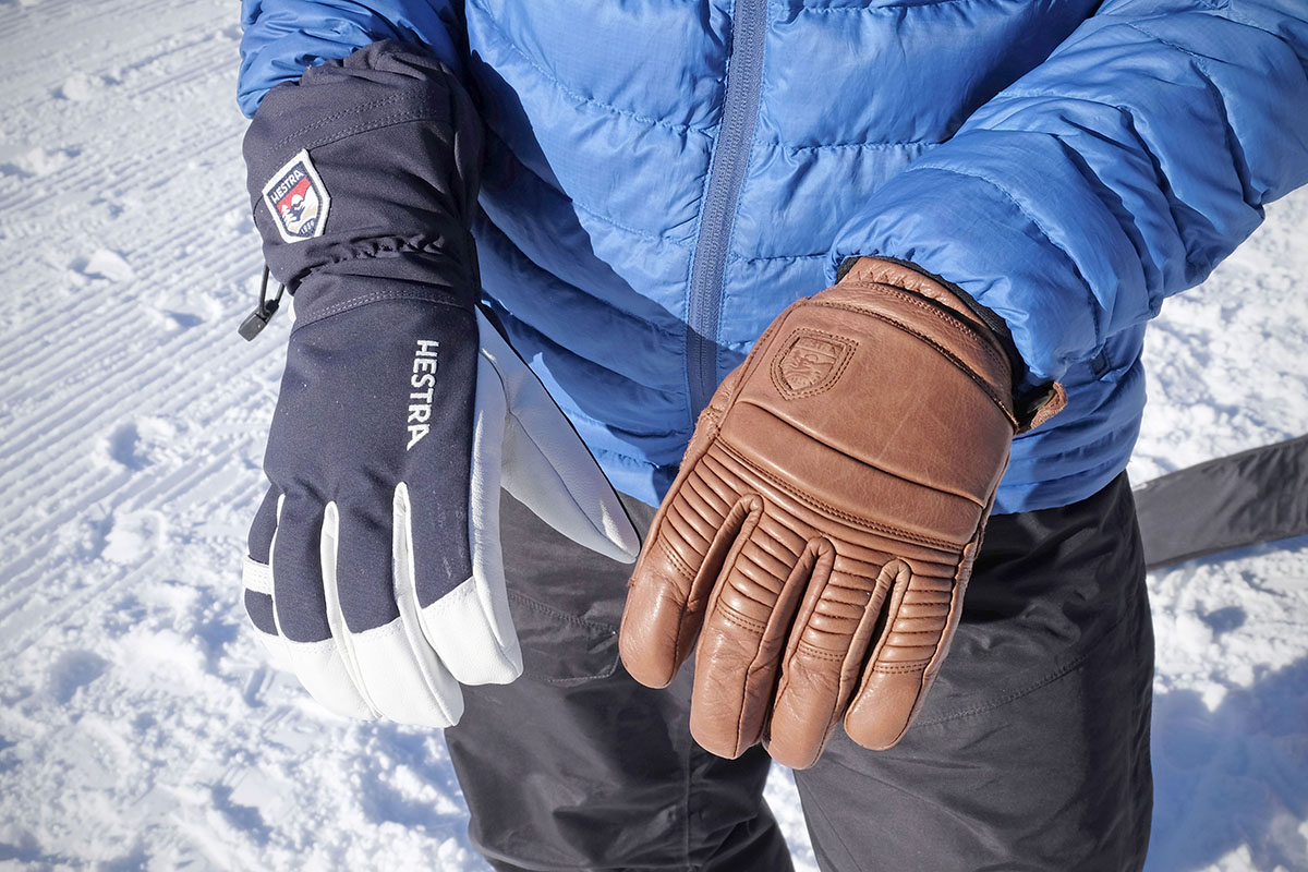 A gauntlet and undercuff ski gloves side by side