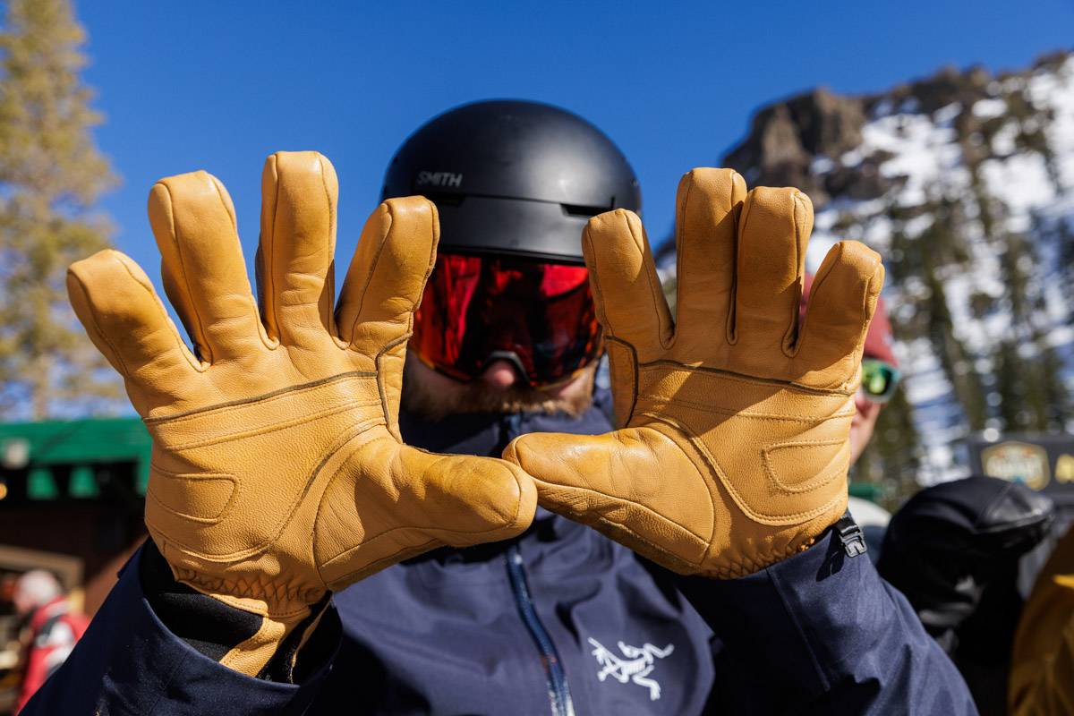 A skier holds up his leather gloves to show off the palms