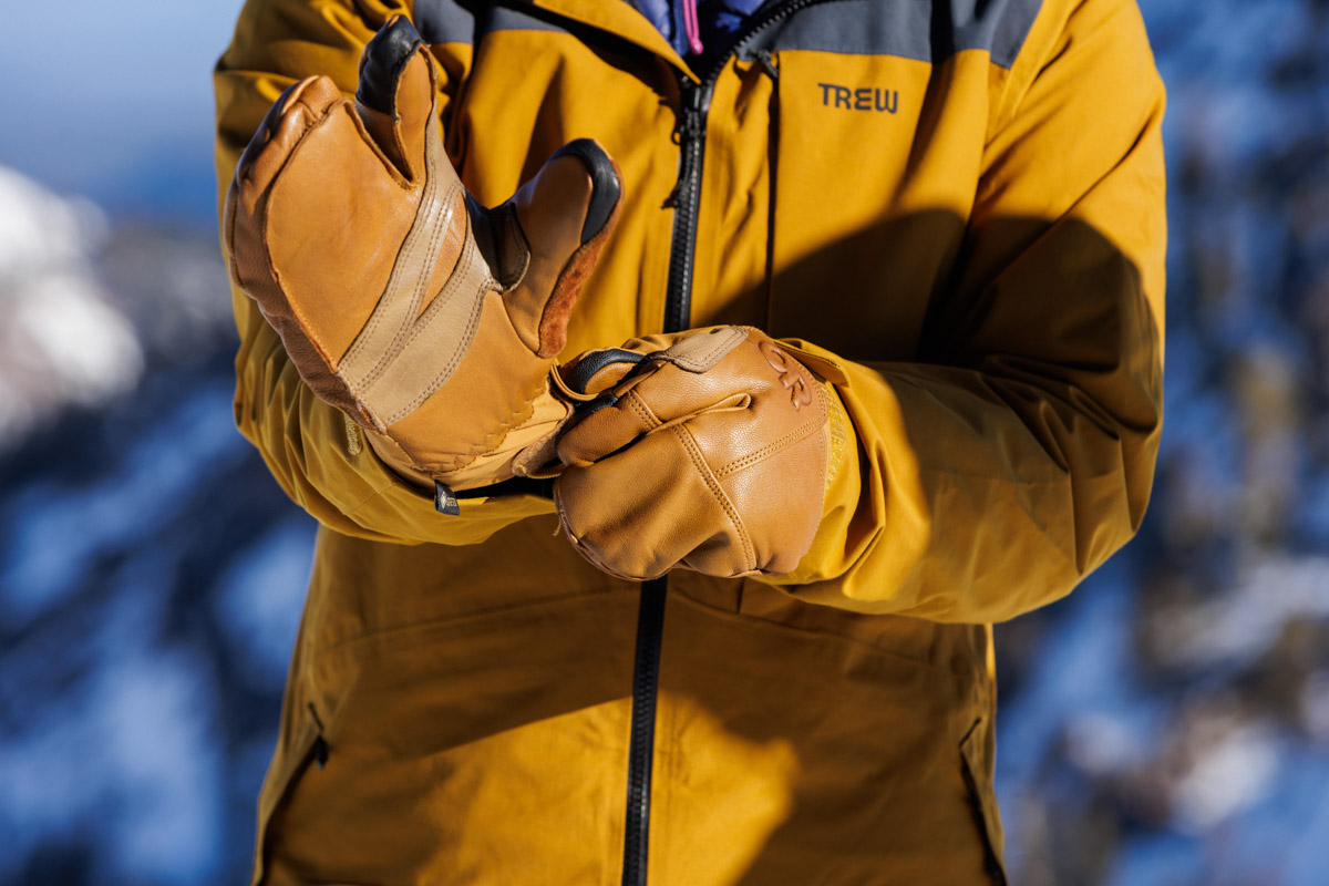 Pulling on a pair of ski gloves