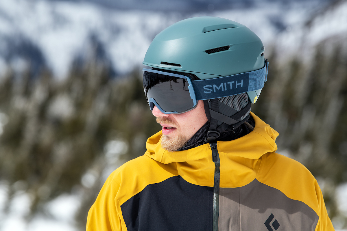 A man wearing the Smith Proxy goggles with Smith helmet at a resort