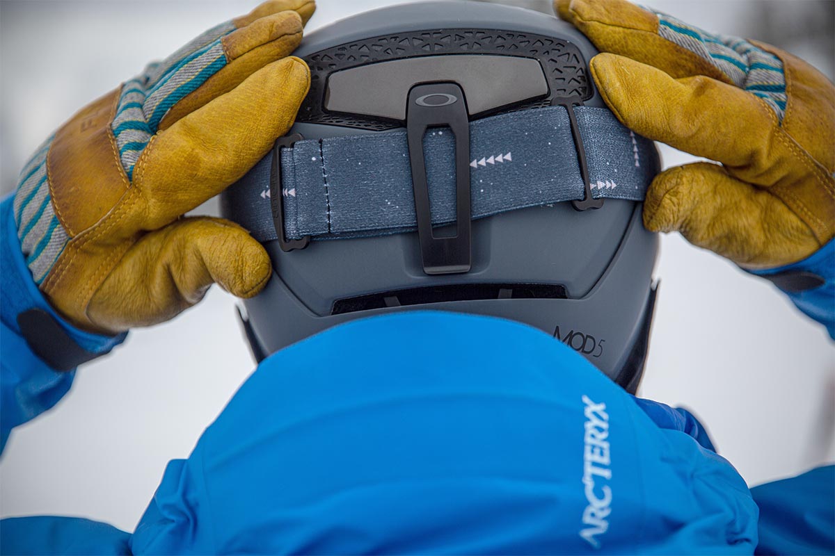 A close up of a goggle retainer on the back of a ski helmet