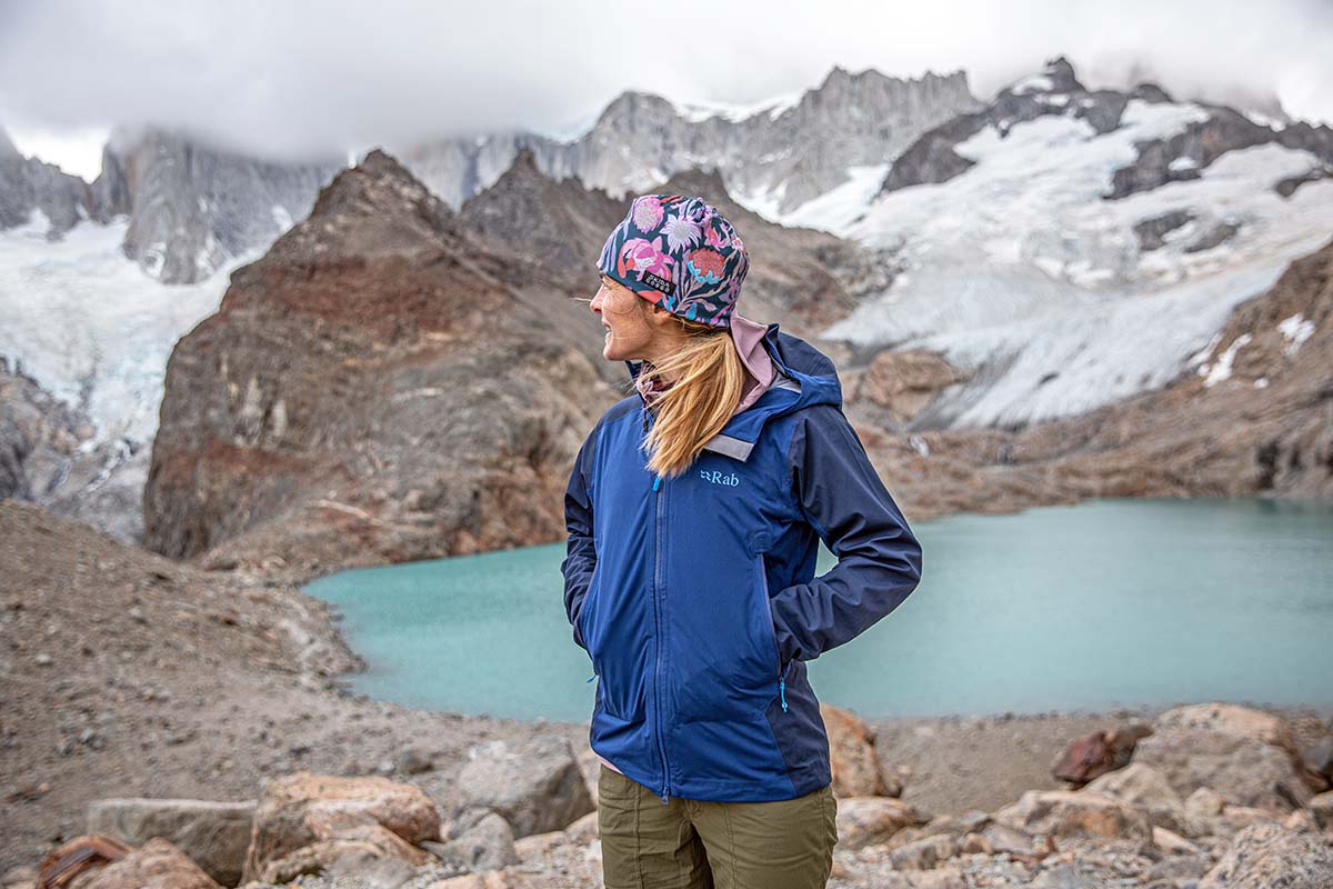 a woman in front of an alpine lake in the mountains