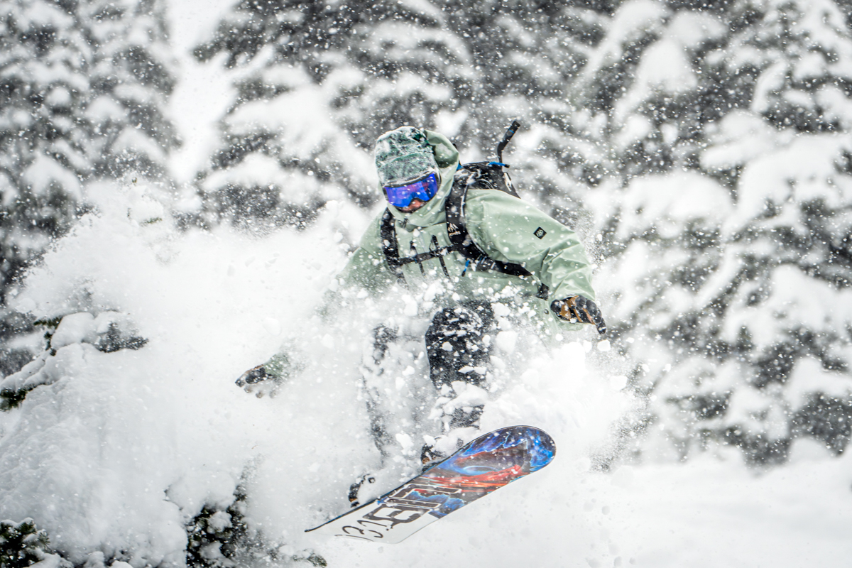 A man riding a snowboard in the powder