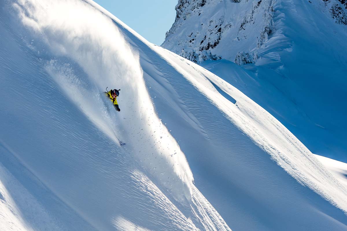 A snowboarder shredding an epic backcountry line