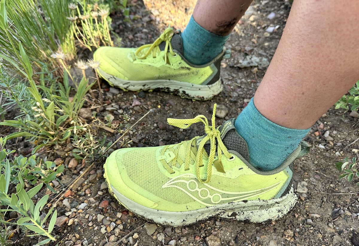 The Saucony Peregrine 15 is shown on the muddy trail 