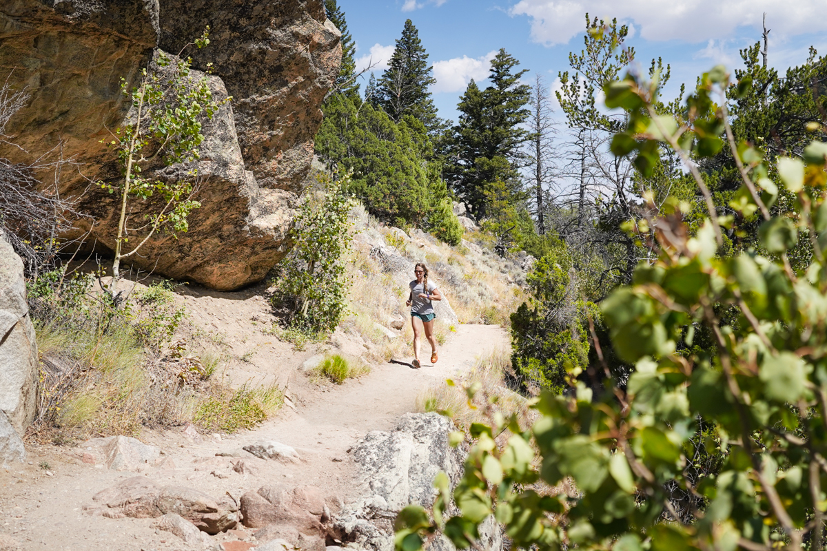 A woman is running on a hot, sunny day in Wyoming.