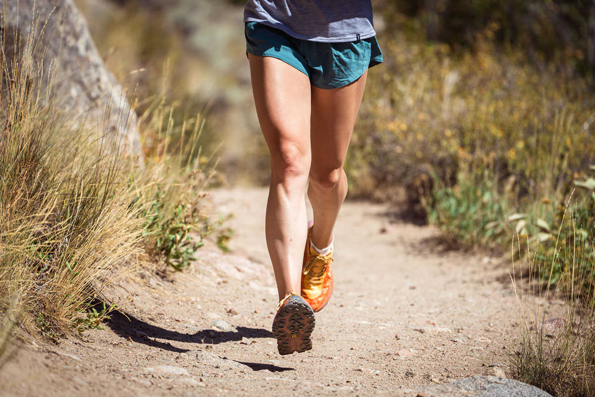 An action shot of Hoka Speedgoat 6, a woman running from the waist down
