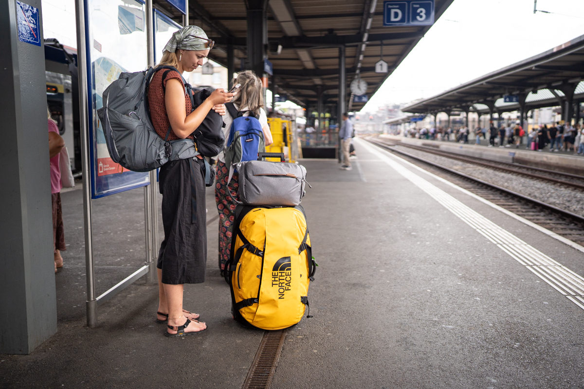 Waiting for a train in Spain with a wheeled duffel
