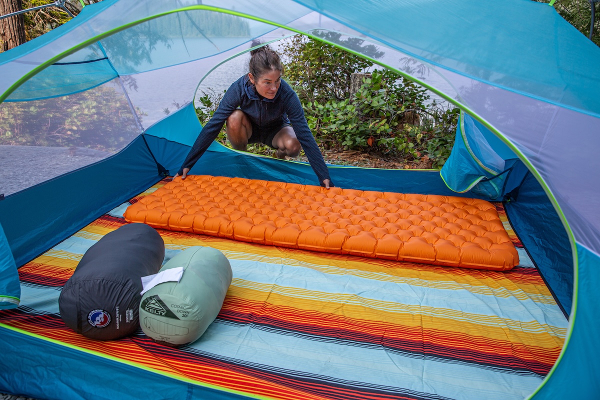 A woman setting up the Big Agnes Zoom UL in a tent
