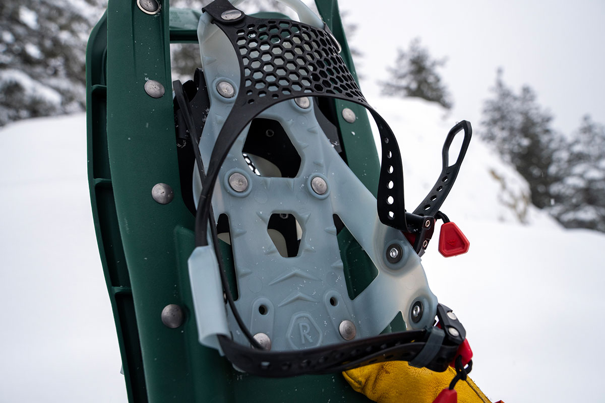A close up of the binding on a green snowshoe