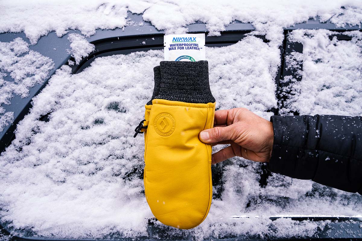 A leather winter mitten with a waterproofing wax packet inside 