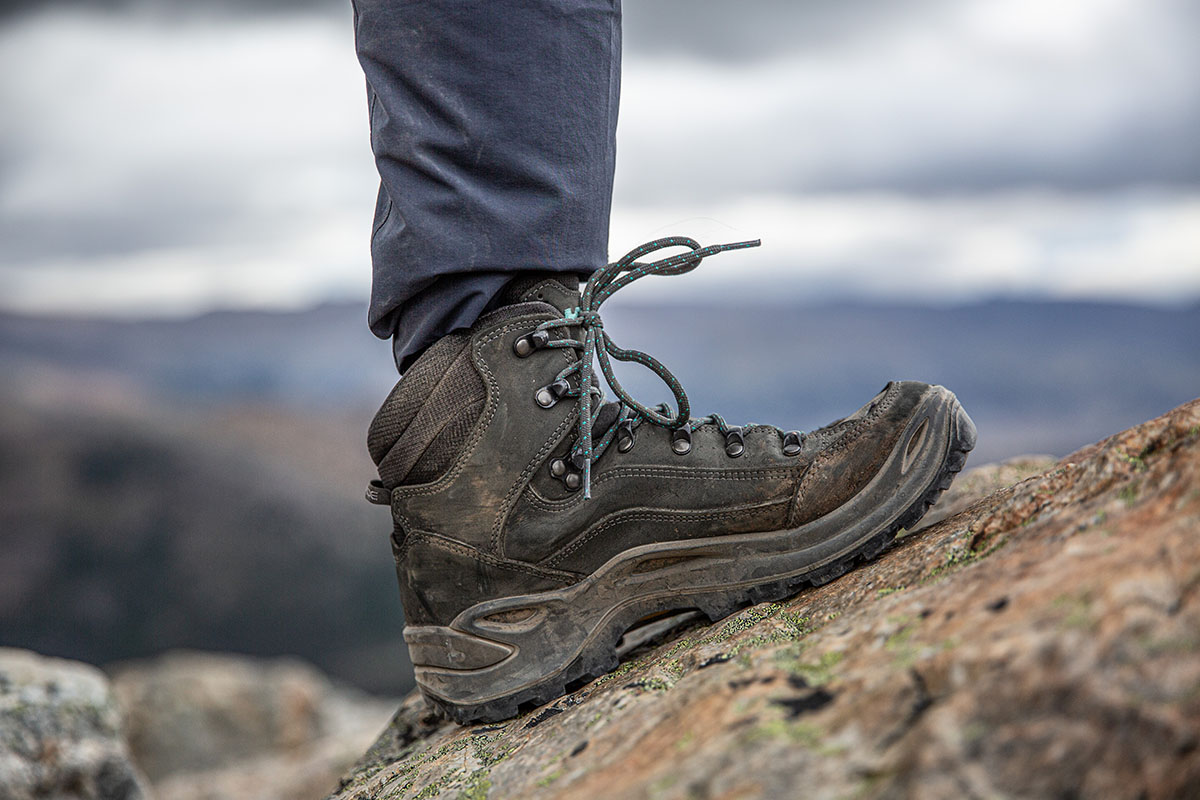 A brown hiking boot on a rocky slope