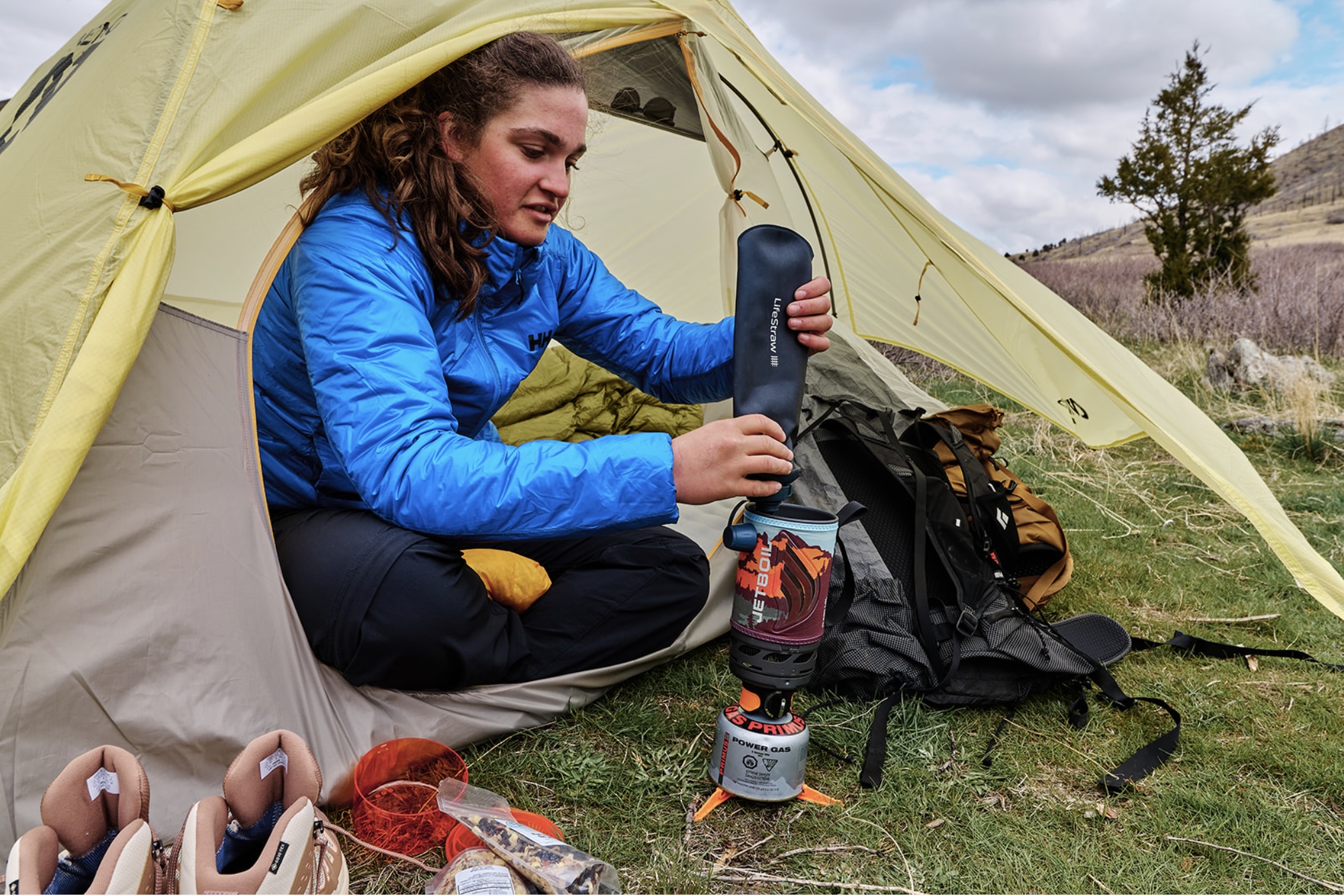 rain jackets women in a tent cooking