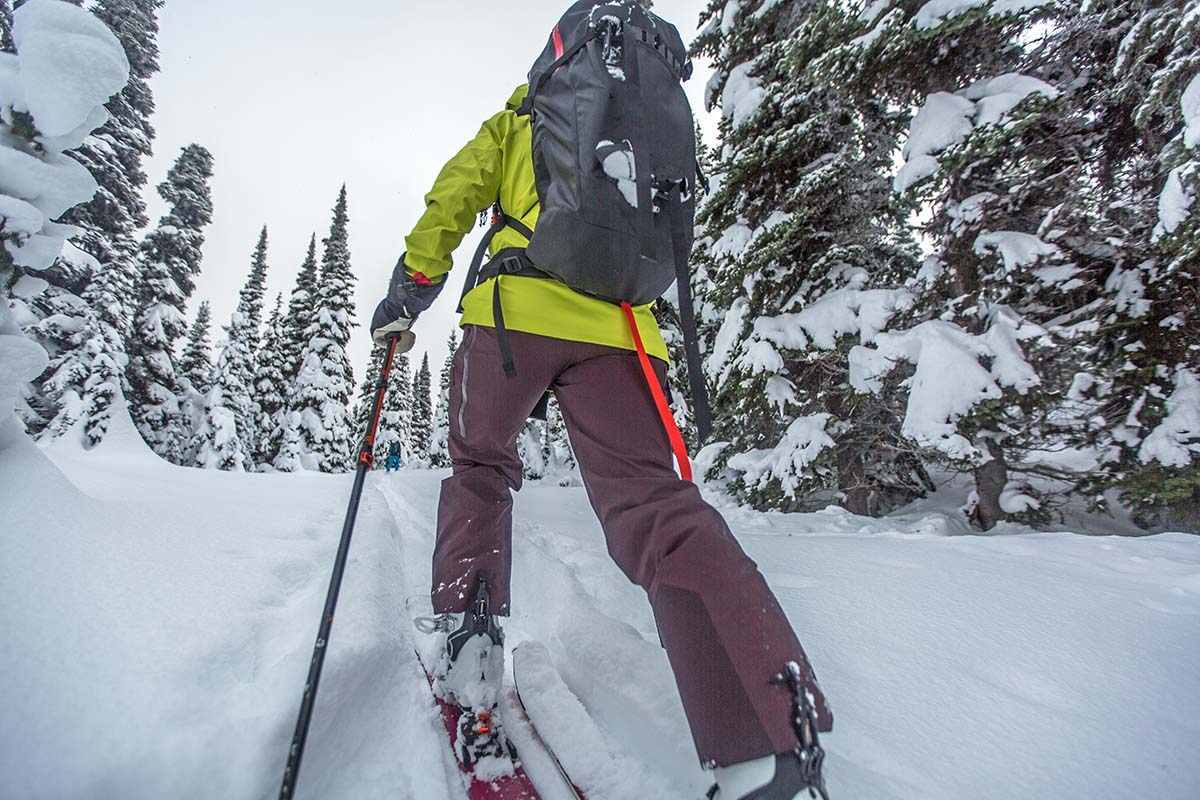 An up close image of the scuff guard on a pair of purple ski pants
