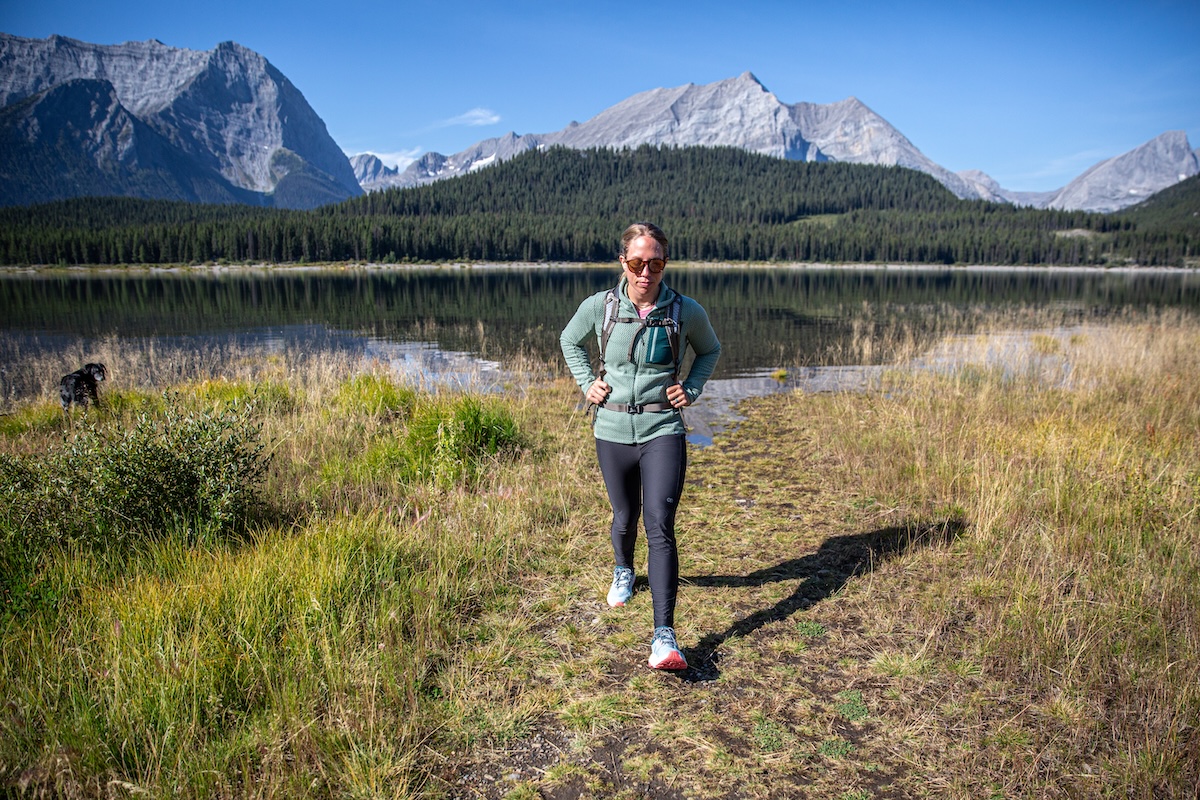 A women hikes in Canada wearing a fleece jacket