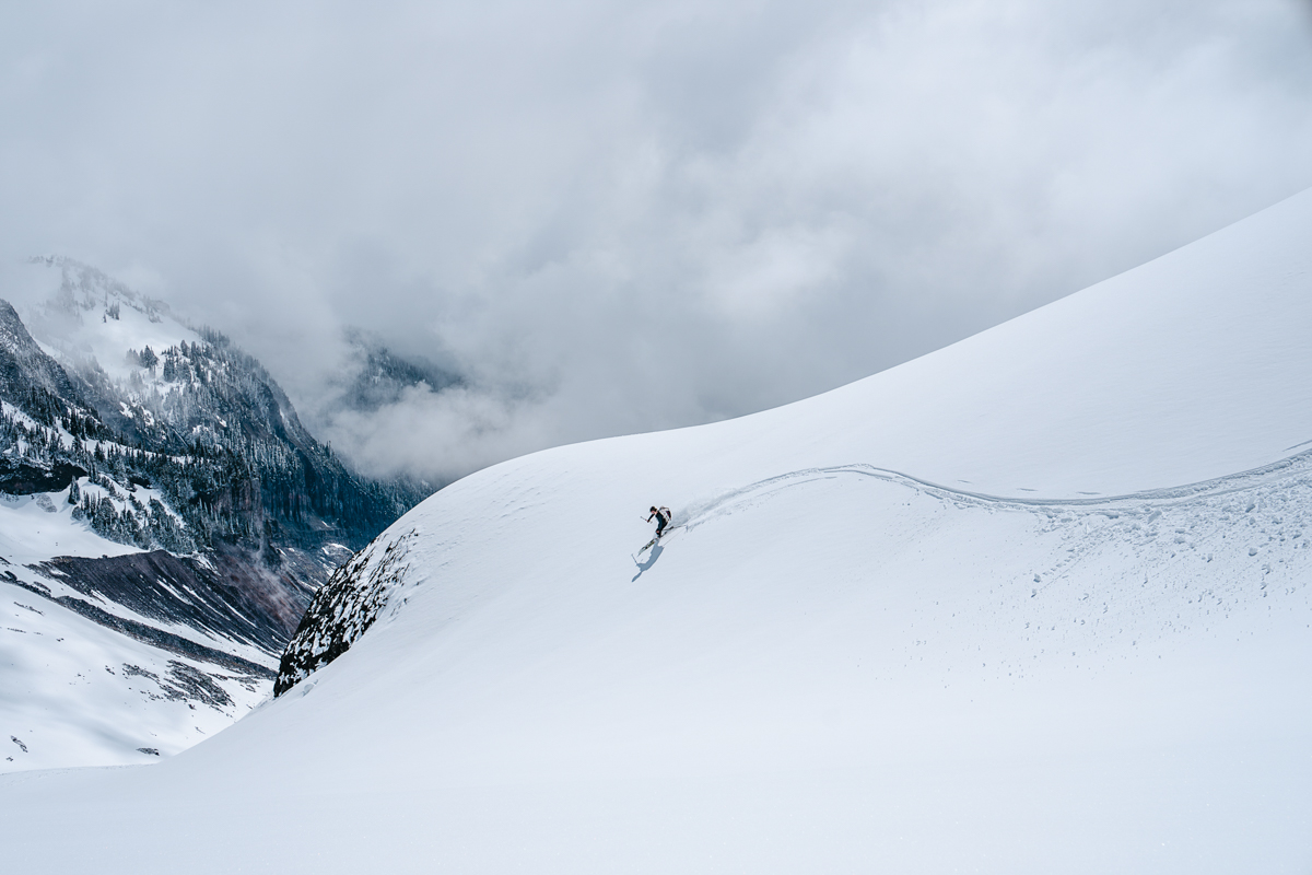 A person skiing down a snowy hill