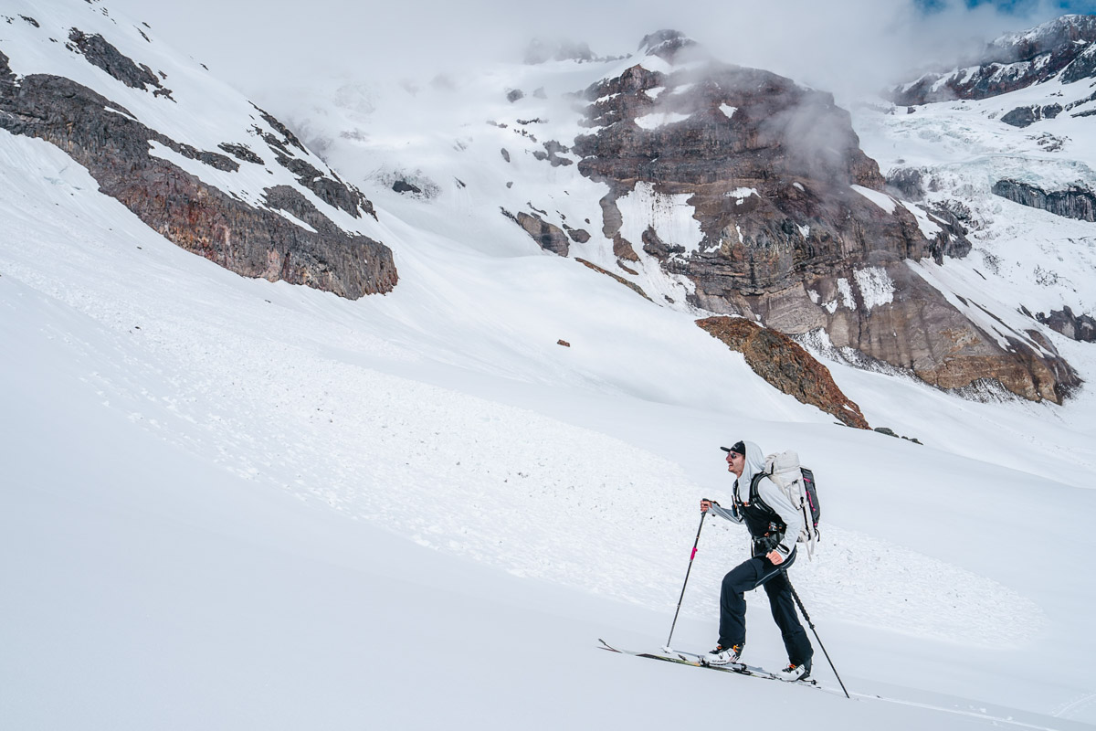 A man skinning up a steep mountain slope