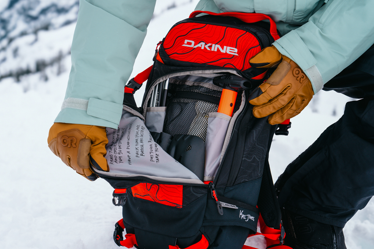 Opening a ski backpack avalanche pocket