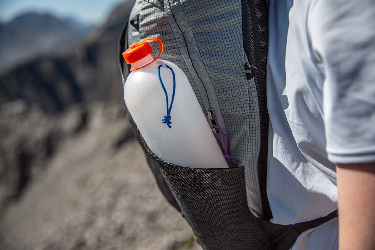 A water bottle in a backpack side pocket
