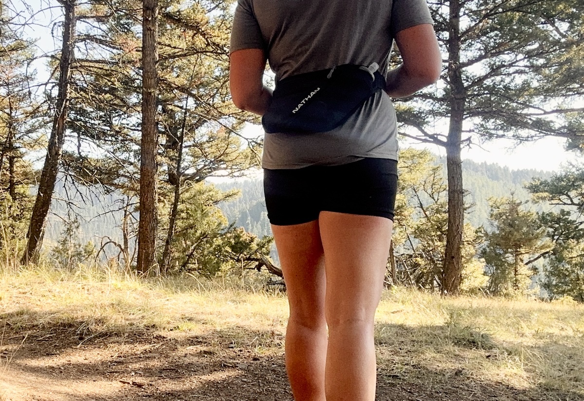 A woman is shown from the waist down wearing a hip belt running pack for a running gift guide suggestion