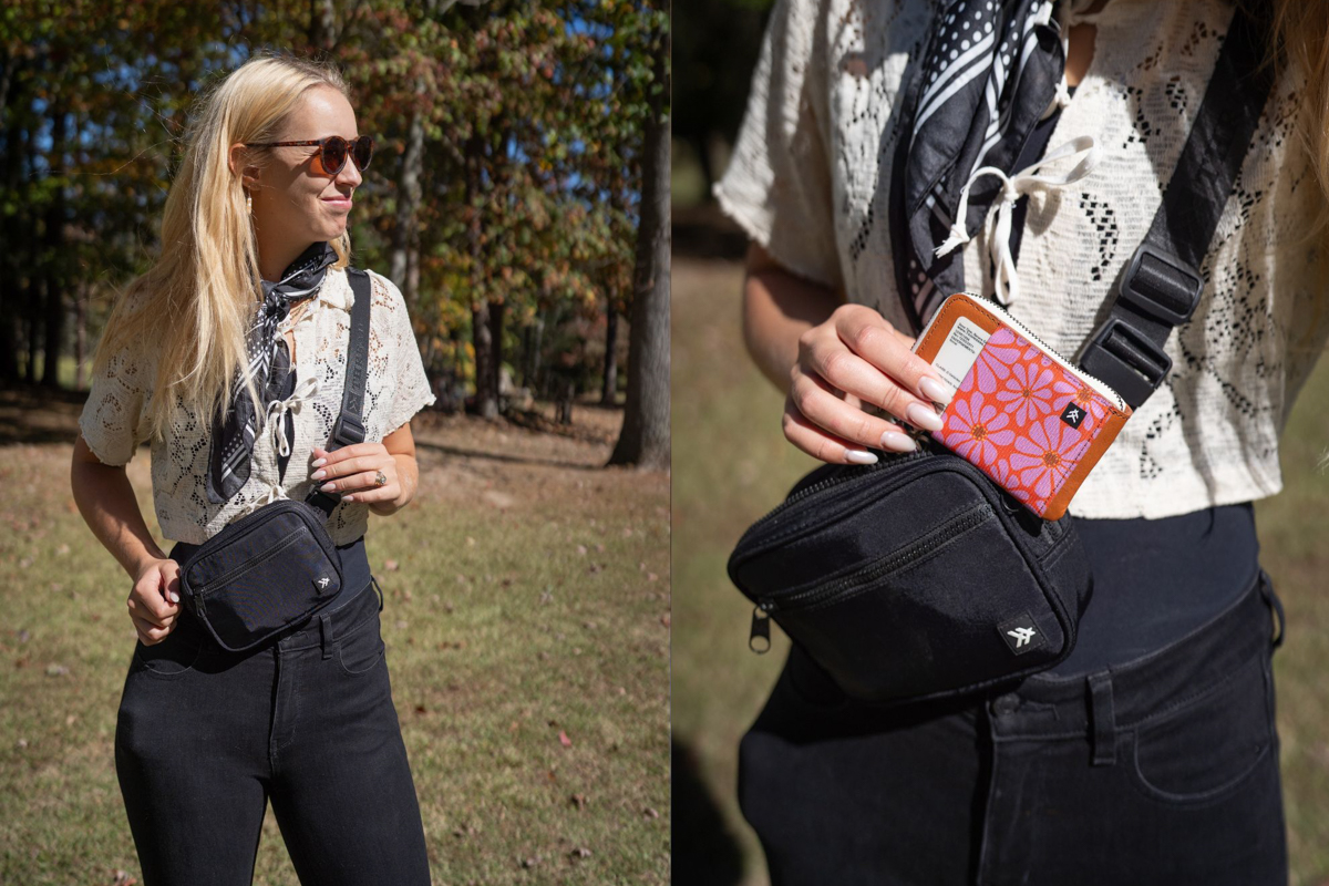 A woman wears a small black fanny pack and stores a small, flowered wallet inside.