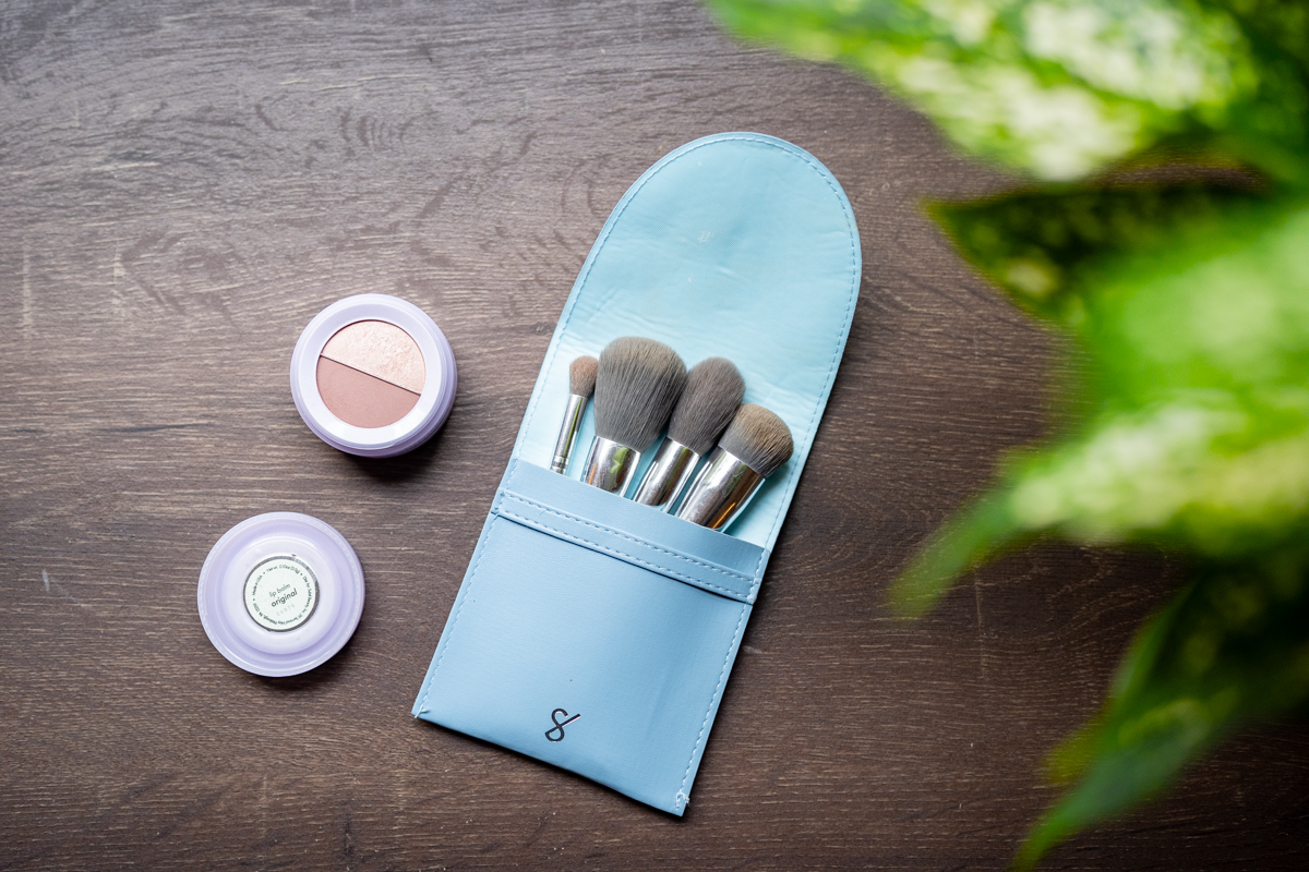 A compact makeup kit with two shades lies on a table.